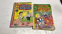 Front covers of two comics: Inventions and Vaults of Mystery