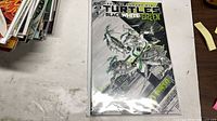 Front view of the bagged Teenage Mutant Ninja Turtles: Black White & Green #1 comic book