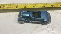Top view of metallic blue Hot Wheels Rolls-Royce Phantom II showing length against tape measure