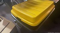 Angled view of bin with yellow lid closed