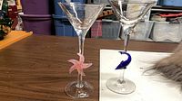 Two decorative martini glasses showing starfish and whale stems