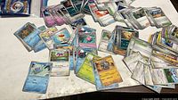 Spread of assorted Pokémon TCG cards on table
