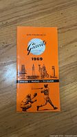 Front cover of 1969 San Francisco Giants media guide, orange background with team artwork