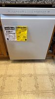 Front view of white LG dishwasher with EnergyGuide label showing 238 kWh/year