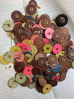 Pile of multicolour emery sanding discs with brass centres