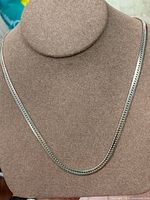 Full front view of sterling silver chain on display bust