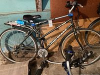 Full view of Land Gear bicycle with bike rack stand in foreground