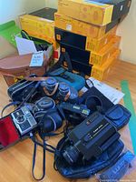 Group shot showing cameras, binoculars, slide trays and cases