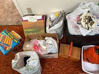 Overview of lot showing bags with yarn, needles, knit magic machine box, wooden box and tote