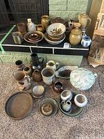 Group shot of all pottery items on hearth and floor