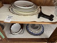 Shelf with assorted platters and plates top and bottom