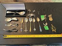 Group shot of all spoons, jewellery and measuring tape