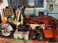 Overall view of tools, extension cords, circular saw, hardware drawers, protective gear