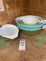 Stacked set of four mixing bowls with oval casserole and lid