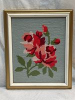 Front view of framed needlepoint showing full floral design and frame