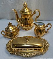 Full set showing coffee/tea pot, sugar bowl, creamer, and covered butter dish