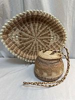 Both items: oval tray rear and lidded basket front.