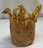 Side view showing amber swirl body and all four swan handles