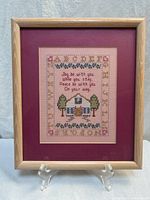 Full view of framed sampler showing frame, mats, and entire design