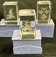 All three crystal blocks on their boxes showing etched designs