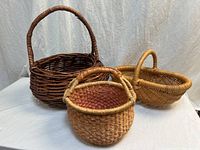 Three handwoven baskets grouped together showing shapes and colors
