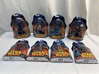 Group shot of eight sealed Star Wars Episode III figures displayed upright