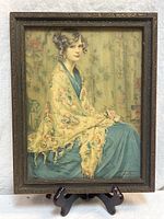 Full view of framed lady portrait on stand