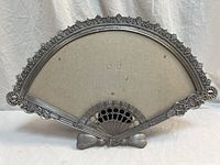 Front view of fan-shaped metal picture frame showing overall design and condition