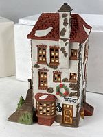 Front view of porcelain building showing sign and entrance