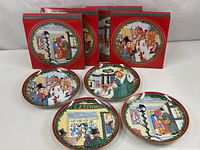 Group shot of four plates with their red Department 56 boxes