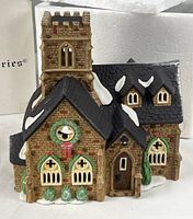 Front angled view of Knottinghill Church showing wreath, windows, snow on roof