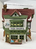 Front view of porcelain building showing signage and fish crates