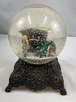 Full view of Department 56 snow globe on ornate base