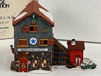 Front view of Blue Star Ice Co. building with stone foundation, blue star sign and snow detailing