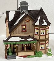 Front view of porcelain Jeremiah Brewster House showing porch, turret and snow detailing