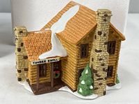 Front view of porcelain Timber Knoll Log Cabin showing sign, wreath, snow detail