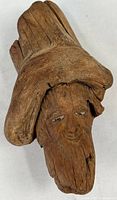 Front view of carved driftwood face showing full piece