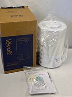Humidifier, box and manual set on table