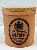 Full view of terracotta biscuit jar with cork lid