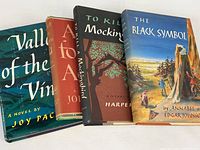 Front view of all four novels side by side showing dust jackets