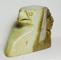 Left angled view showing eagle head profile and partial human face