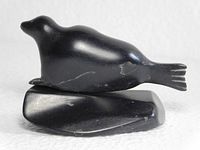 Right profile of seal carving on ice floe base