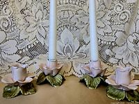 three rose candle holders with tapers to show scale and function