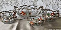 Set showing one large and three small bowls with hand-painted floral design
