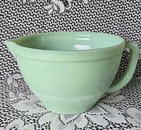 Side view showing full shape, handle, and spout of jadeite batter bowl