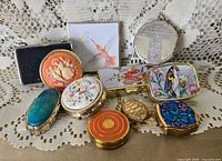 All 11 pill boxes laid out showing lids and designs