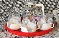 Full set on tray showing teapot and four cup assemblies