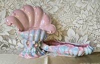 Front view of nautilus shell vase and console bowl showing Mauve Agate glaze