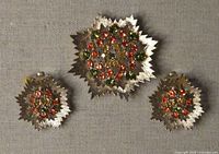 Front view of brooch and earrings showing rhinestones and gold-tone design