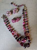 Full lot showing beaded necklace and both pairs of earrings